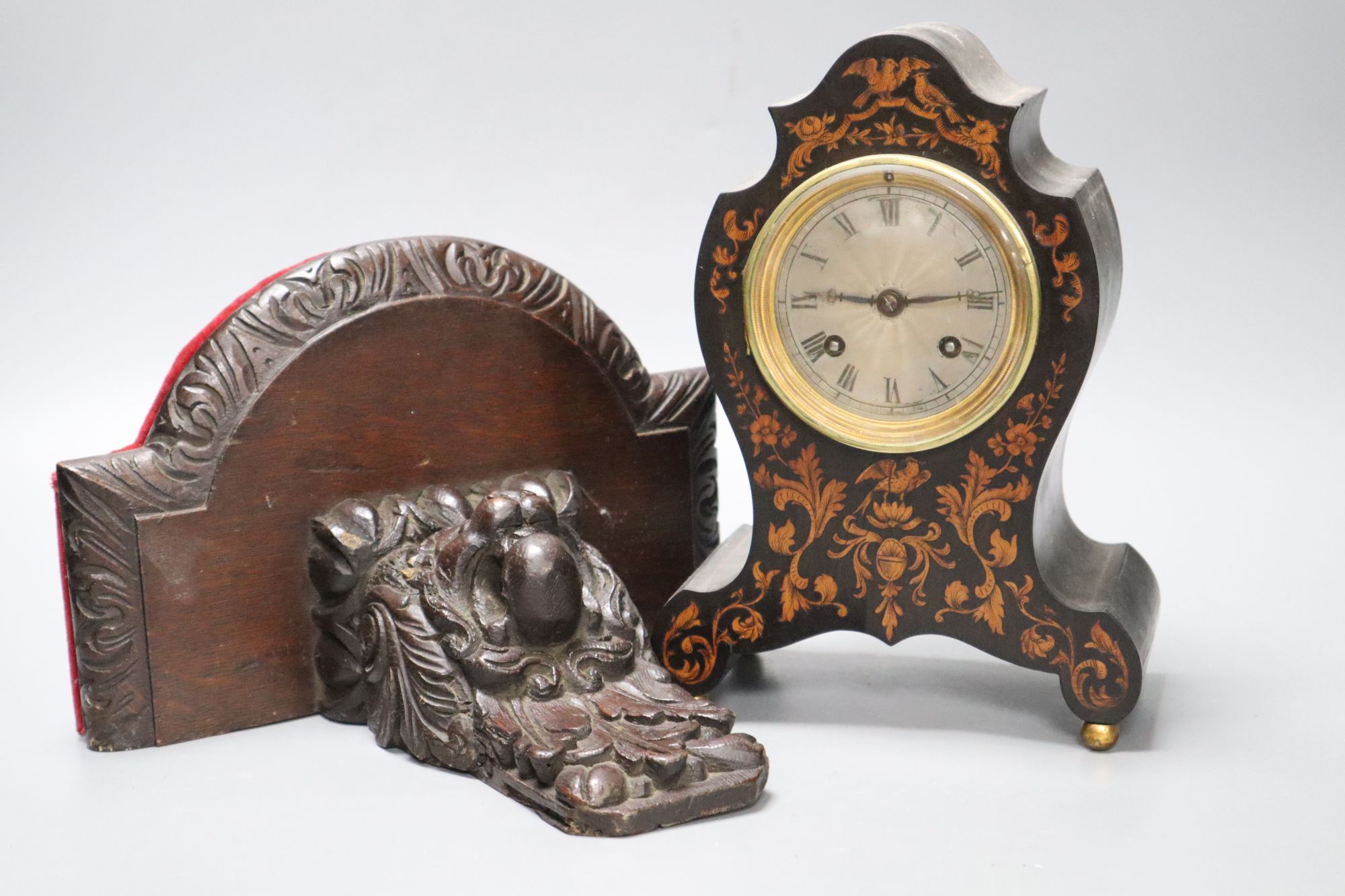A 19th century marquetry inlaid mantel clock, height 23cm, together with a carved oak bracket